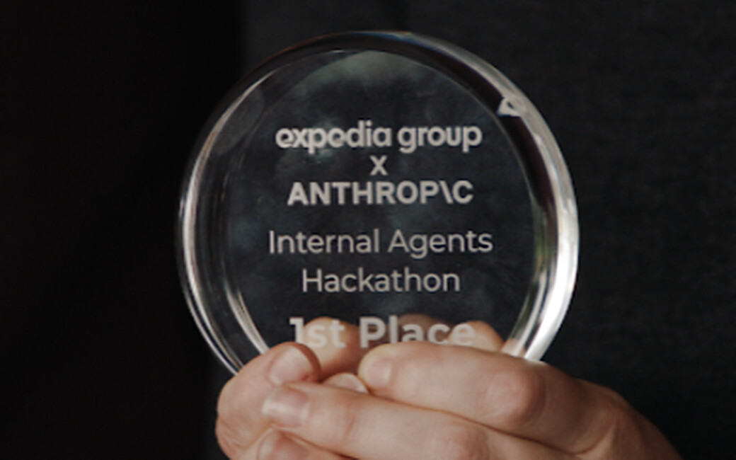 A builder holding the first place trophy from an internal hackathon with Anthropic